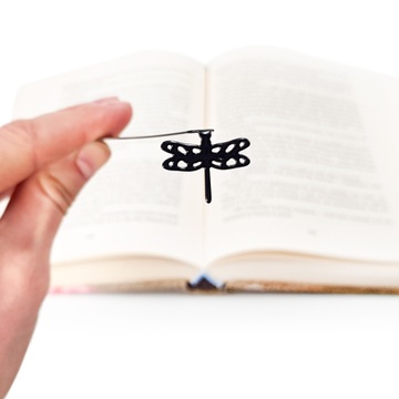 Sturdy metal bookmark Dragonfly. A flat metal stick stays between the pages of the book. A silhouette of the dragonfly is on the side of the book. It is visible even when the book is closed. Designed and made by us in our workshop in Cherkasy, Ukraine. No