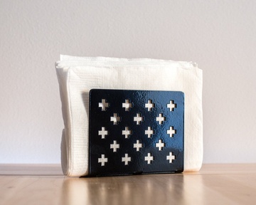 Modern black metal napkin holder Crosses. Minimalist kitchen accessory for stylish interior